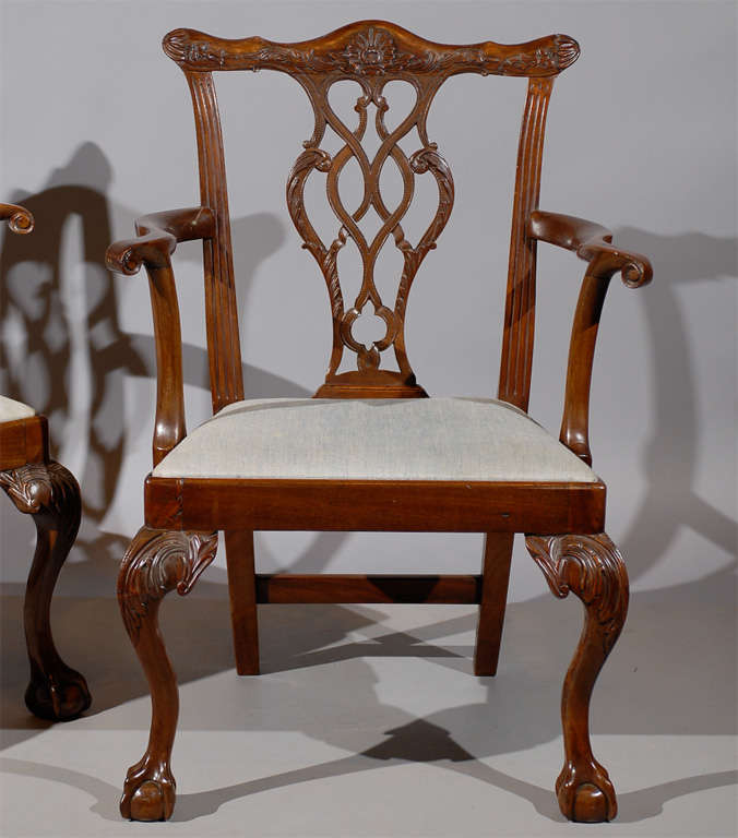 A pair of Irish Chippendale armchairs in mahogany with ball & claw feet.