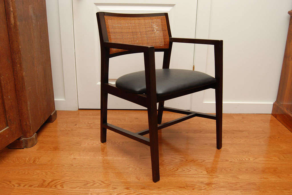 Mahogany armchair with square caned back, by Dunbar, American, 1950.
Seat upholstered in black leather.