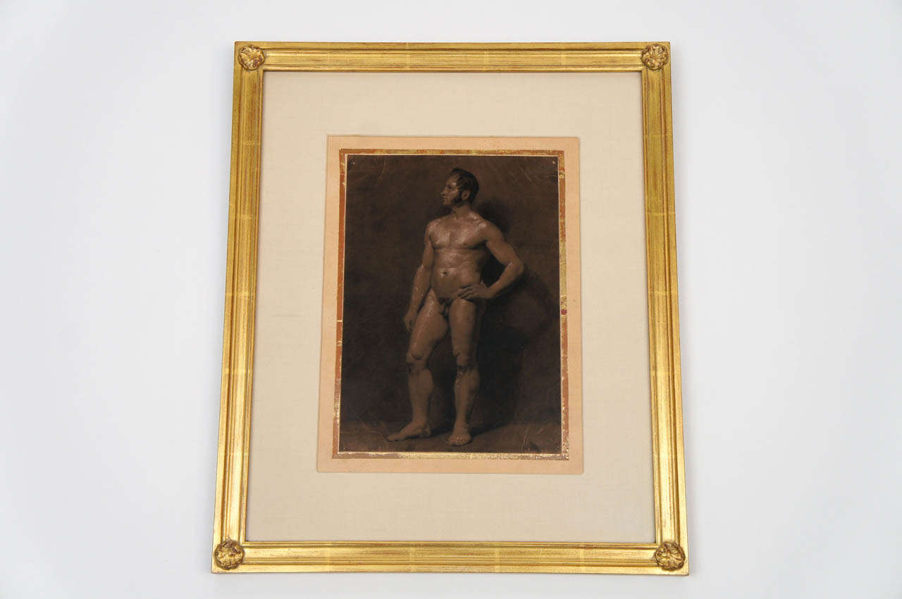 French c. 1810 Empire period sepia ink and gouache painting on paper of an attractive muscular nude male having original applied gilt border on paper.  Contemporary water-gilt frame having corner shell ornaments; silk-wrapped mat.