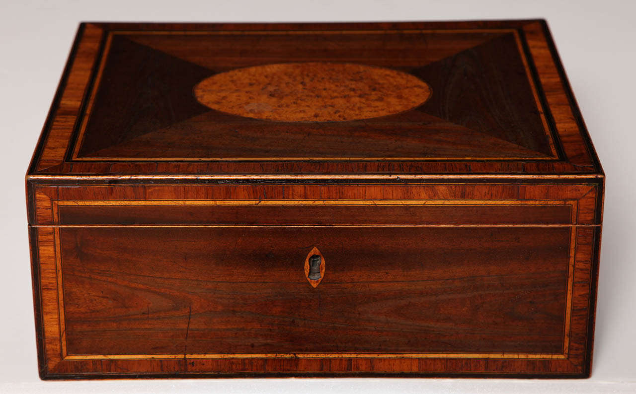 A late 18th century English mahogany and burr yew wood portable writing box
with brass carrying handles and interior fitment with original blue paper lining