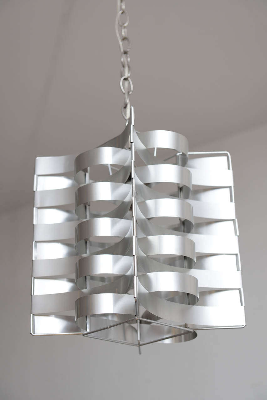 Beautiful aluminum chandelier made of interlocking strips by Max Sauze. This item is in perfect shape and was in made in the 70's in France.