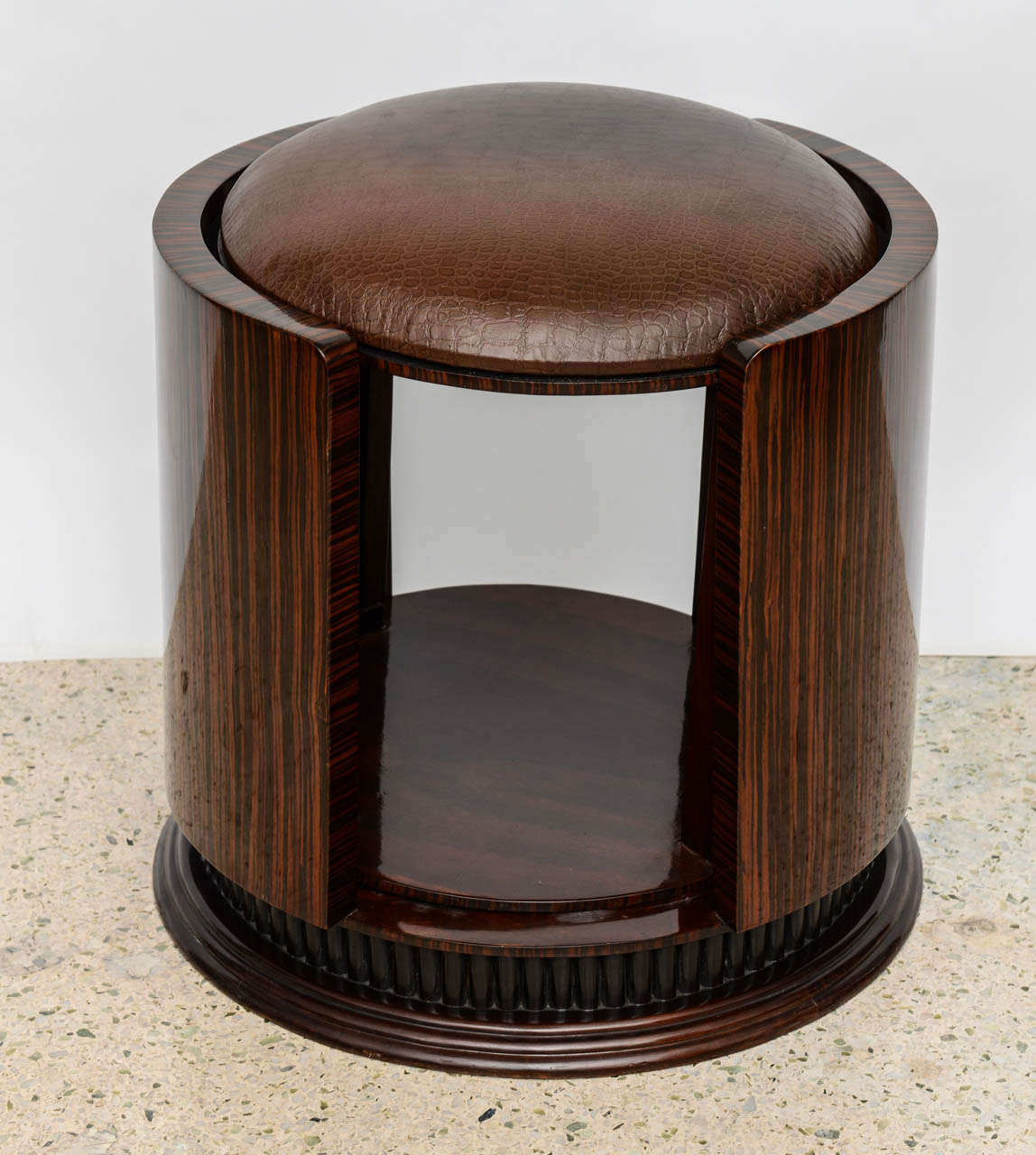 the leather seat above a rotating center within a framework on a fluted base