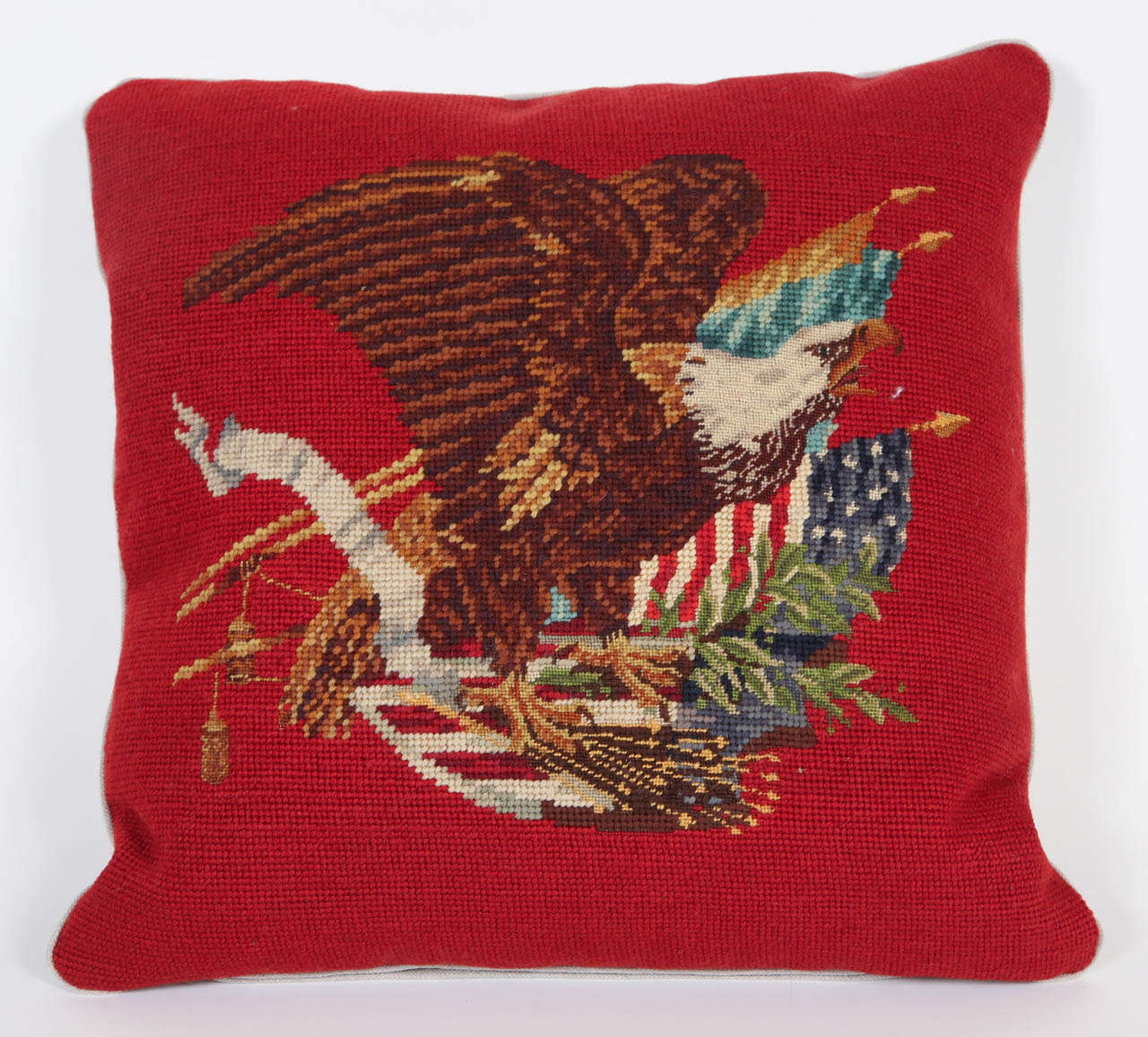 Vintage needlepoint of eagle and American flag made into pillow with down insert.