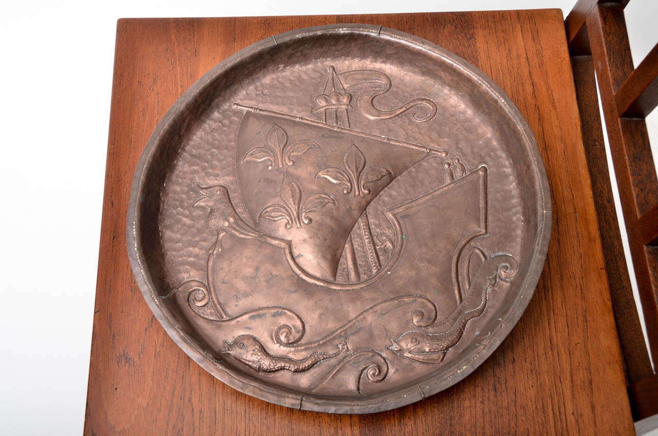 Exceptional Deep-rim Copper Charger by English Craftsman John Pearson.  Bold relief ornament:  Galleon in Full Sail with Waves and Fish.  The prow of the vessel is a smiling creature.  Exceptional weight.  Signed and Dated.