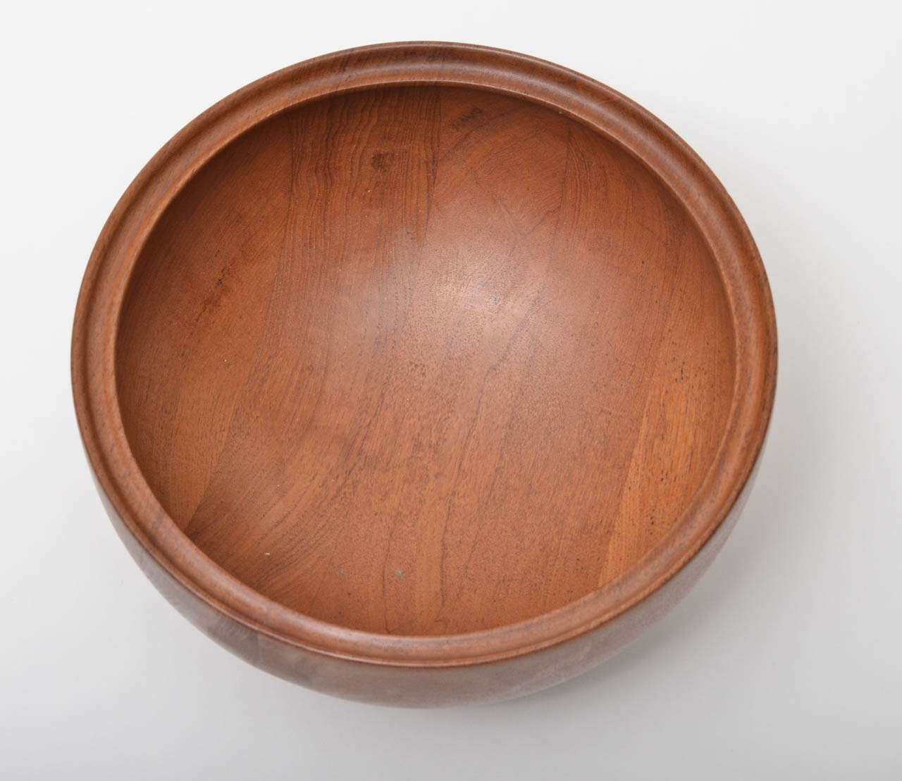 Hemispherical Bowl made of Teak.  Double Rim reinforces the nice heft of the wood.  Facsimile stamp signature:  Henning Koppel.  Made in Denmark