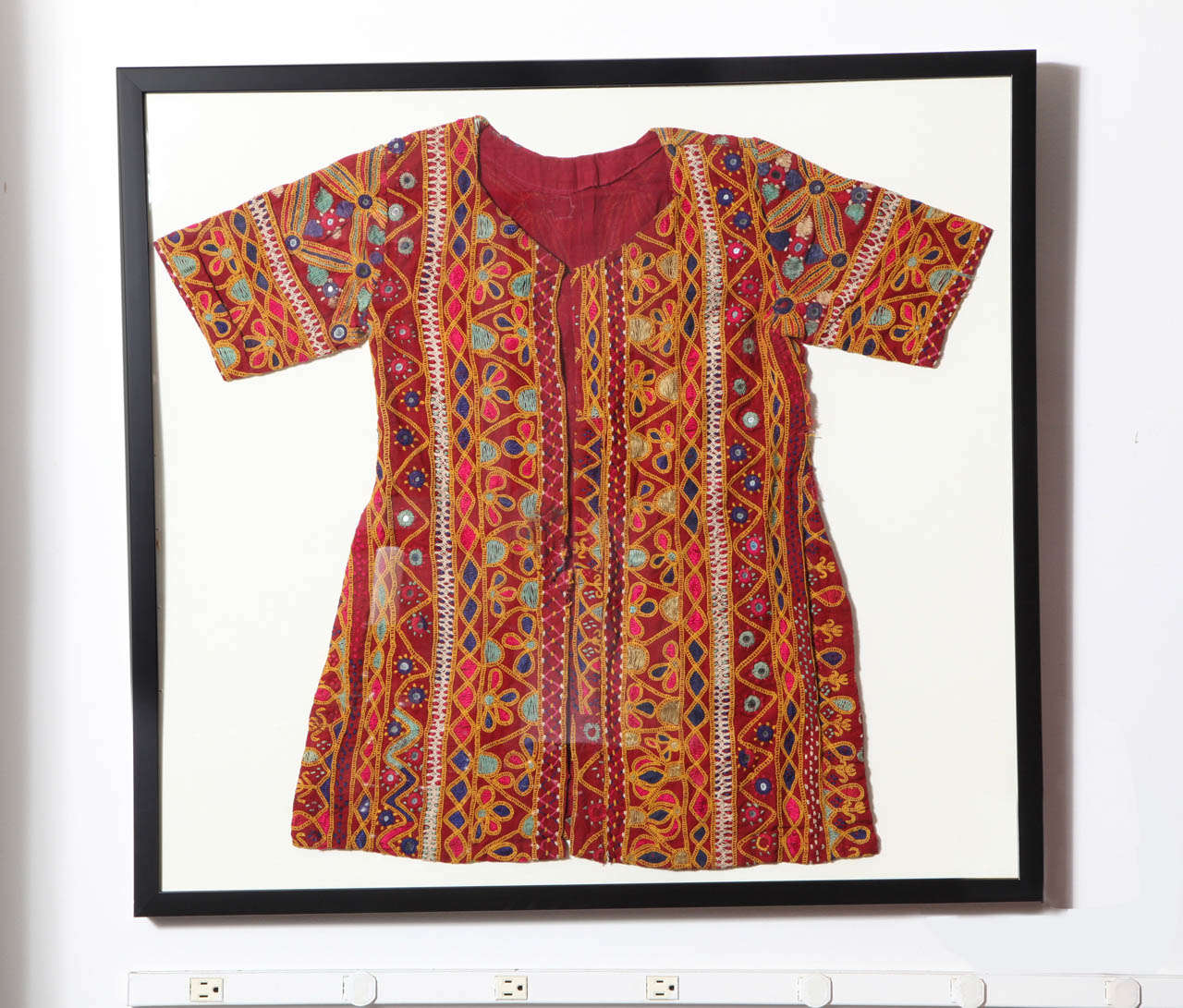 A hand-embroidered ceremonial dress from India, framed. Other similar items available.