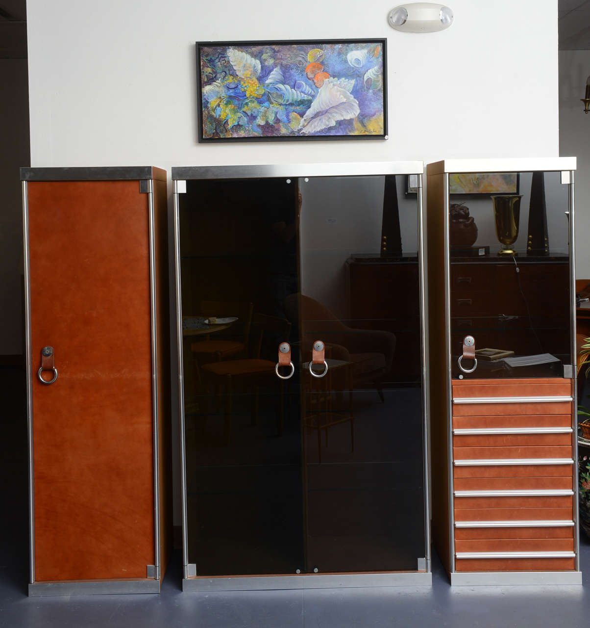 Set of three cabinets by Guido Faleschini, Italian, Midcentury.
The central part opening by two glass doors (glass shelves inside).
Dimensions: 67"X 39".5 X 18"
The two side independent parts. The front part of each one in