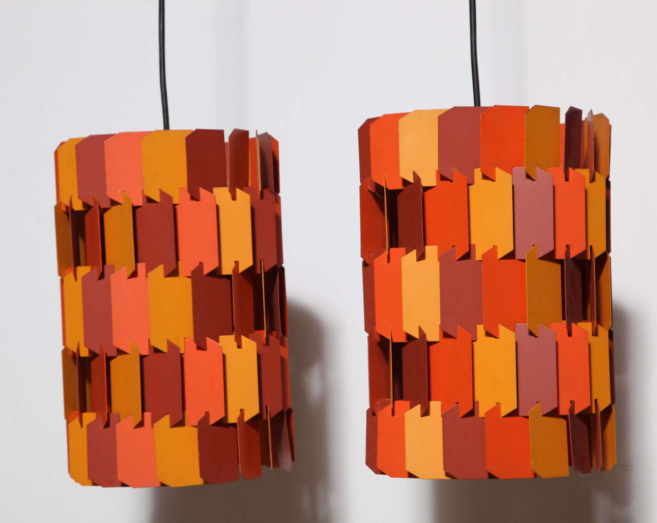 Original Pair of Danish Modern Louis Weisdorf for Lyfa Ballerup Multi Colored Hanging Lamps, early 1970's. Featuring faceted cylindrical forms with castellated Orange, Muted Rose and Pale Mustard enameled Aluminum interlocking Jigsaw style pieces.