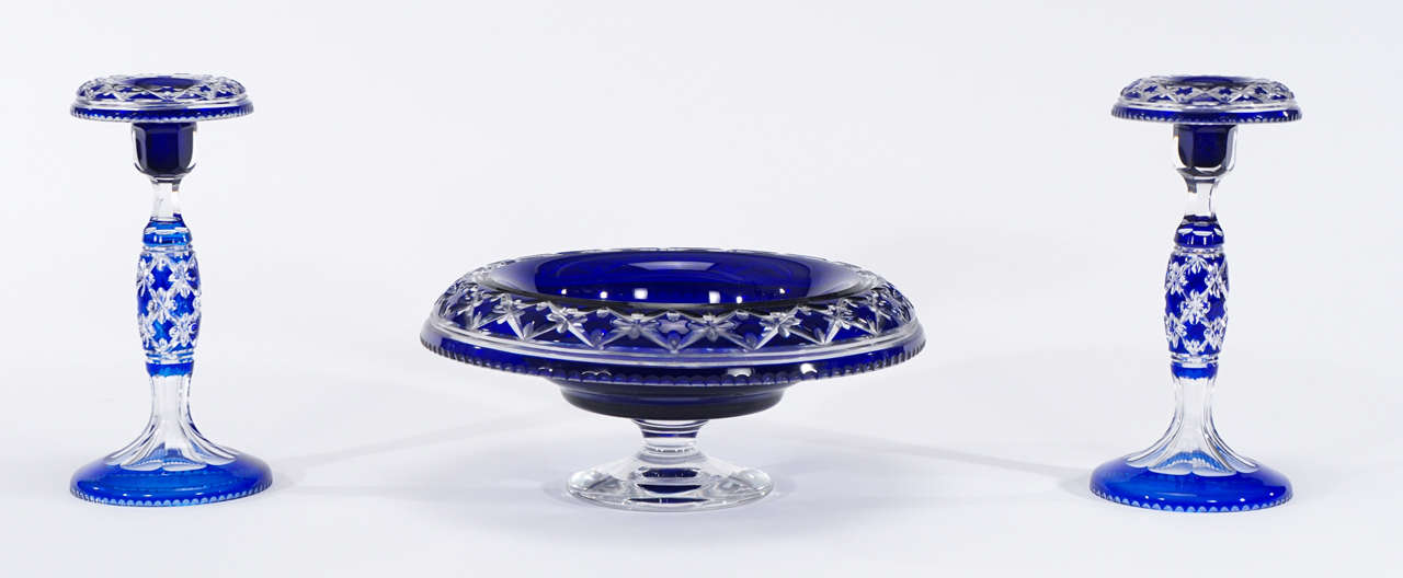 One of Val Saint Lambert's most sought after patterns, this three-piece centerpiece set is handblown crystal, with cobalt blue overlay and cut to clear in the "Cathedral" pattern. The lovely footed centerpiece is the ideal vessel for a low