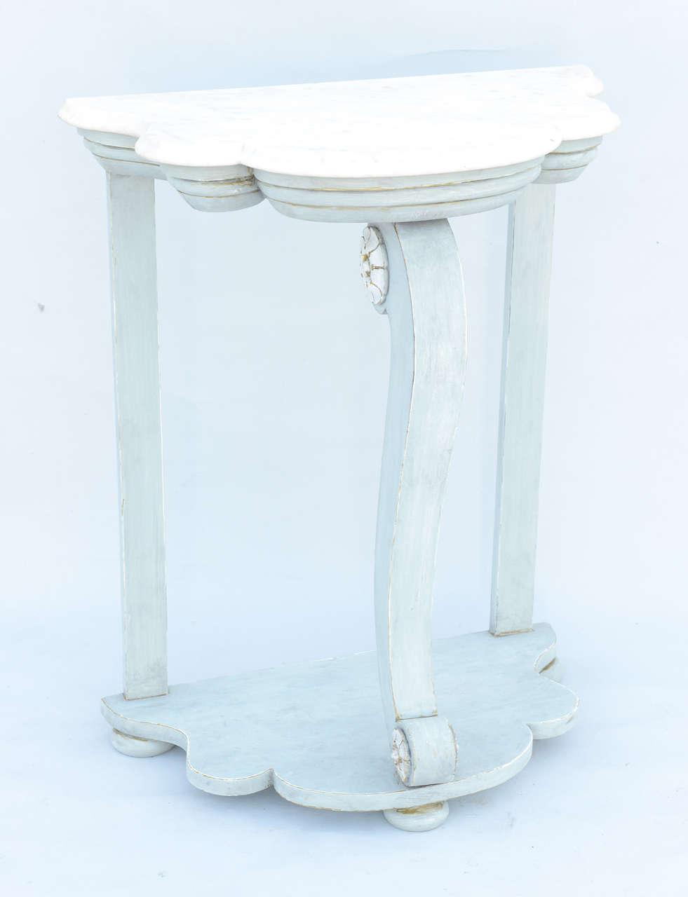 Console table, having a free form top of Carrara marble, on conforming base with a painted finish showing natural wear, raised on central S-scroll leg decorated with rosettes, raised on bun feet.

Stock ID: D3430