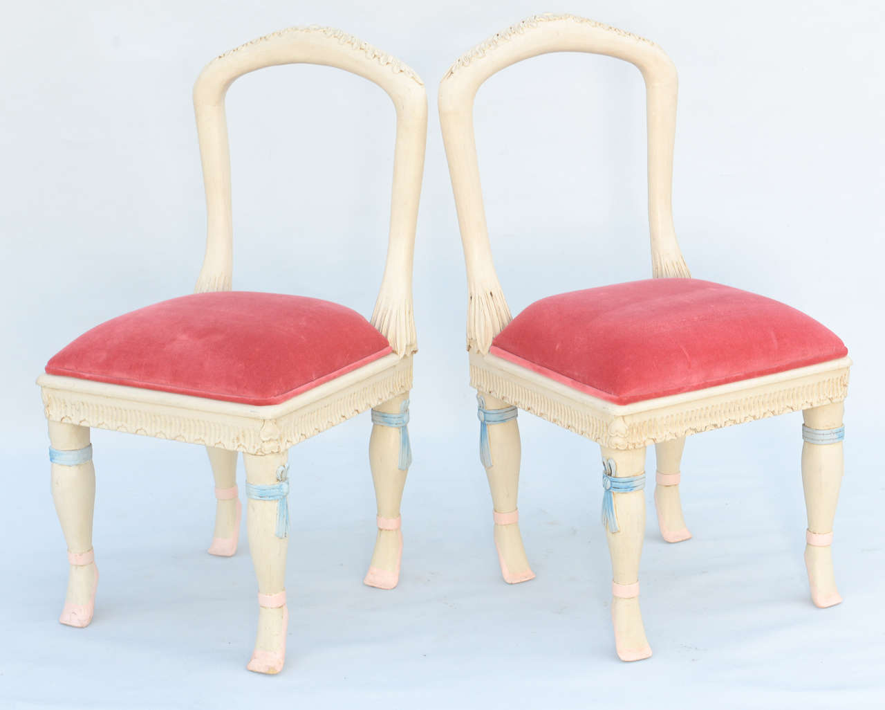 Set of four chairs, having painted finish showing natural wear, each having open arched back rests, drop-in crown seat on straight apron, raised on stylized cabriole legs carved with ribbons and ending in feet shaped as ballet slippers.

Stock ID: