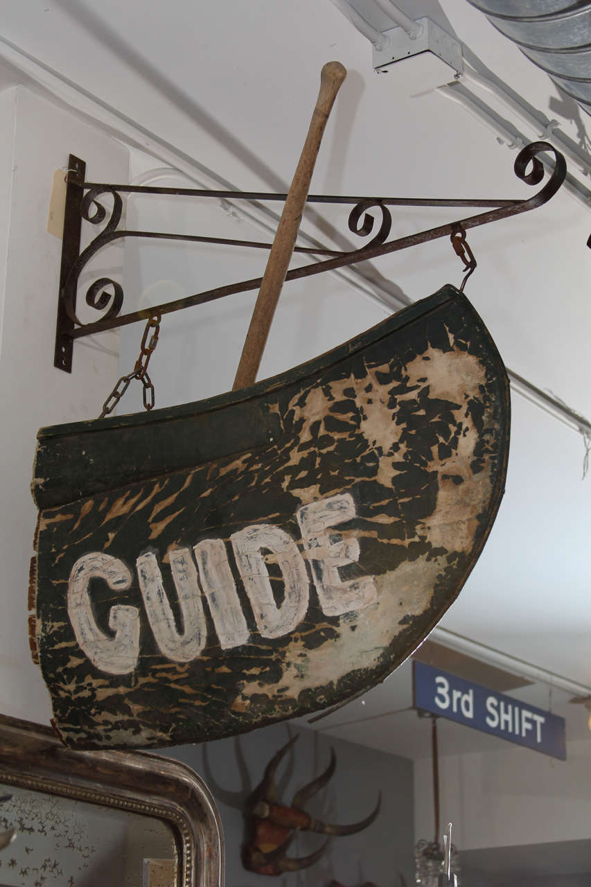 Wonderful handmade Folk Art sign for family run guide service made out of old canoe and paddle.
Original wrought metal bracket holds the sign.