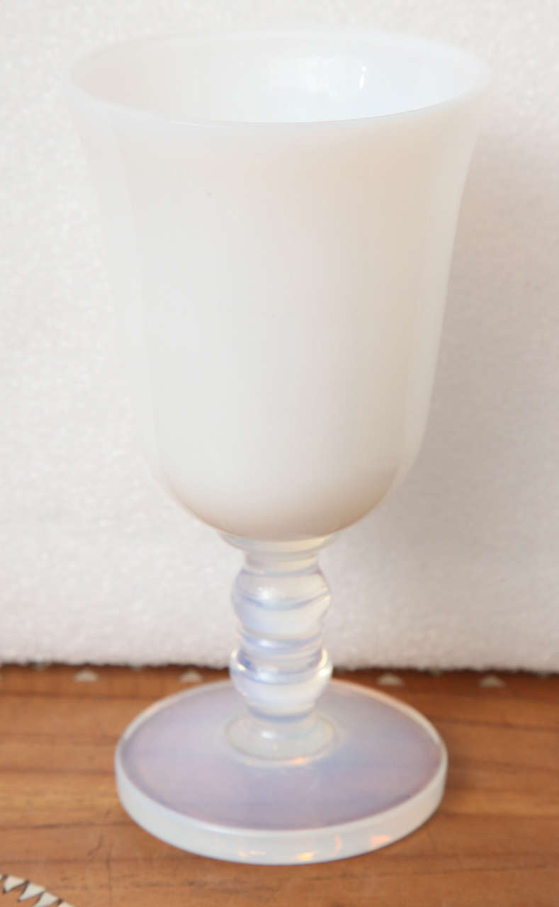 A small white glass stemmed cup from Cristal Sevres, France. Hand-blown.