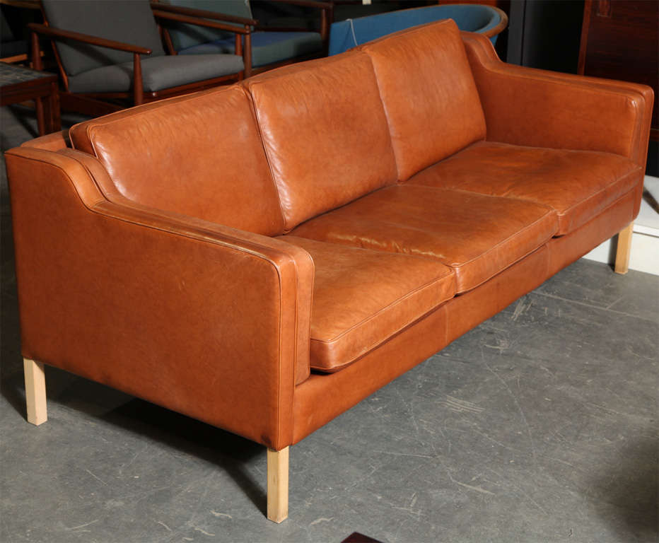 Danish Modern 3-Seater Sofa with Cognac Leather and Oregon Pine Legs echoing the design style of Borge Mogensen.  Features cushion back and seat with swooping arms.  Located at ABC Home 888 Broadway 2nd Floor, New York.