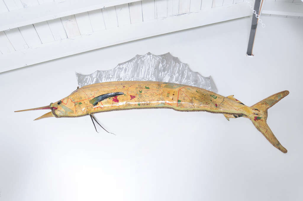 Fantastic folk art sailfish decoupaged in old maps, with aluminum fin.