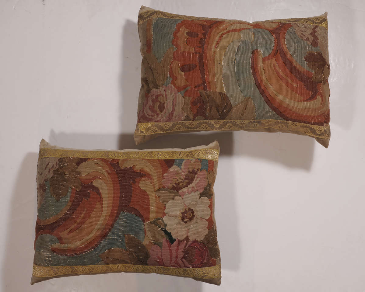 This beautiful pair of antique Tapestry pillows are trimmed out in a Gallon ribbon and backed with a cotton velvet. The 18th Century French tapestry fragments, have been made into custom pillows by Maison Maison.