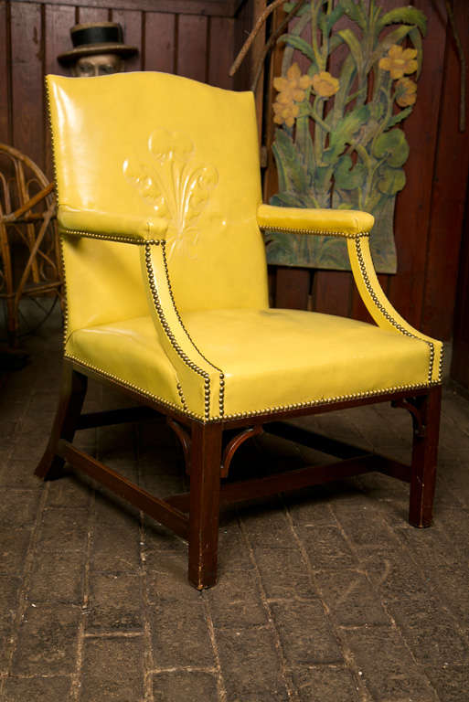 A pair of Grosfeld House yellow leather armchairs with trapunto Prince of Wales plumes on chair backs. Stunning chairs!