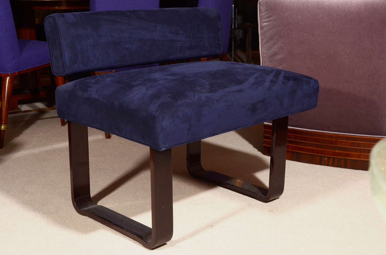 Navy blue ultra suede bench with curved metal legs.