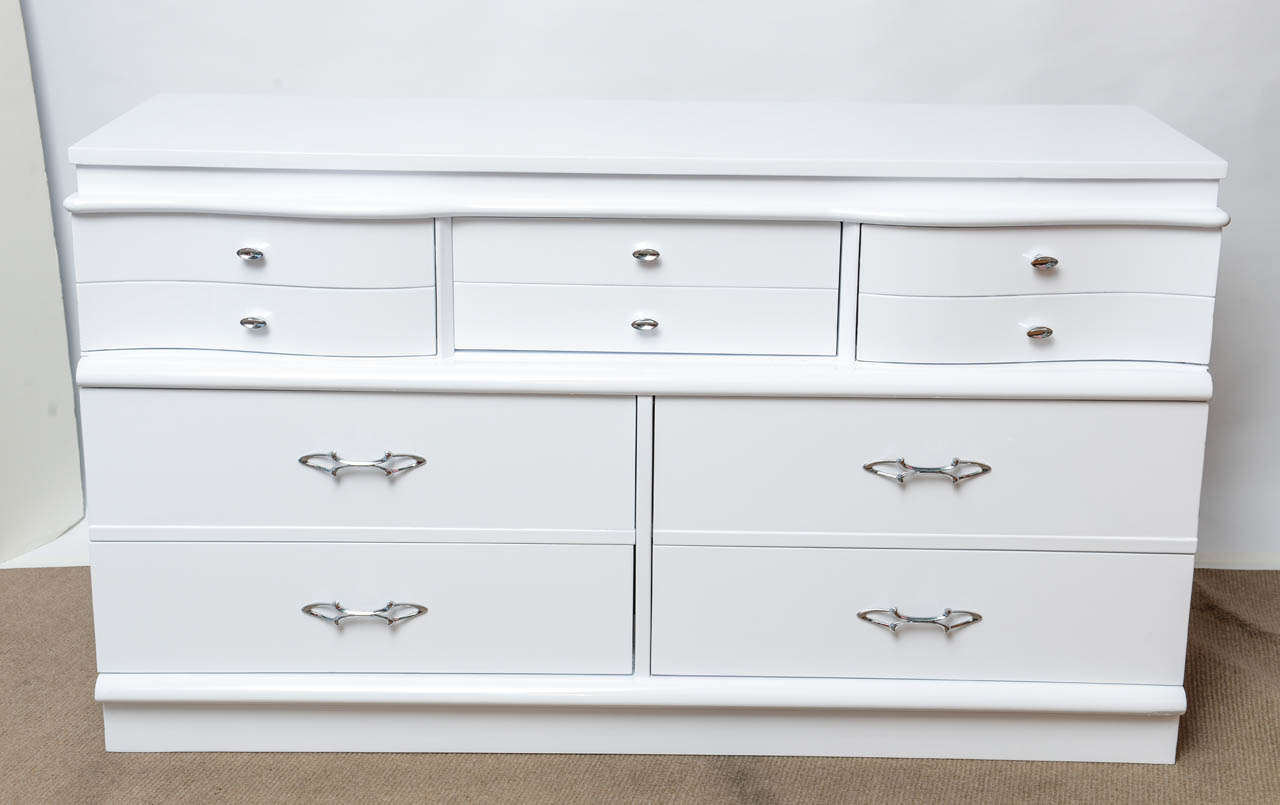 Beautiful and roomy, this perfectly restored 1940s dresser will glamorously store your things!  The classical Regency curves and waves along the front, as well as the original, newly chromed hardware, radiate an understated elegance.  This dresser
