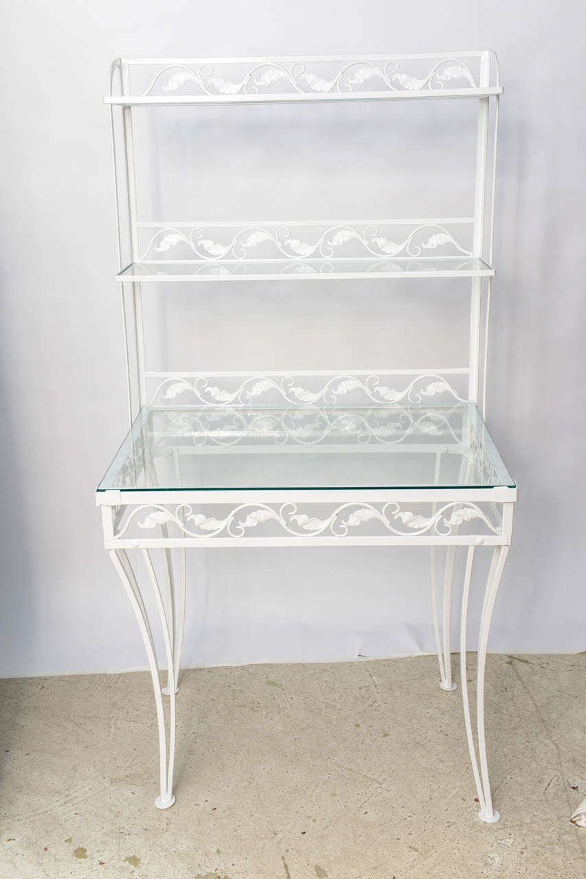 White painted Mid-Century wrought iron étagère/server with three shelves. The largest shelf is 24 in. deep and the other two are both 10 ins.