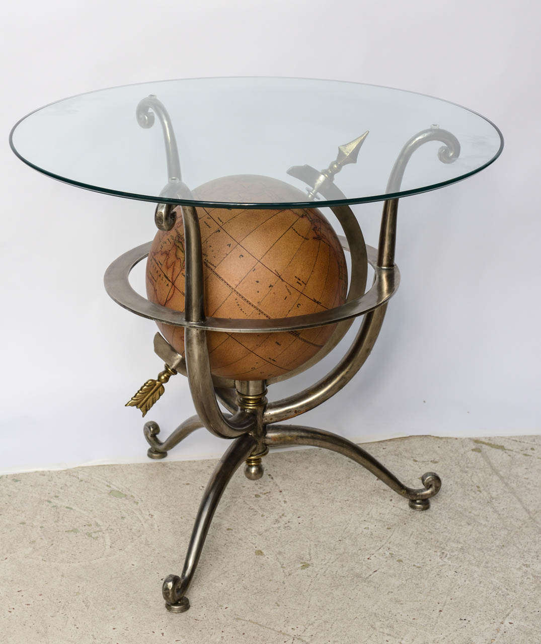Very stylish steel and brass globe side table with glass top.