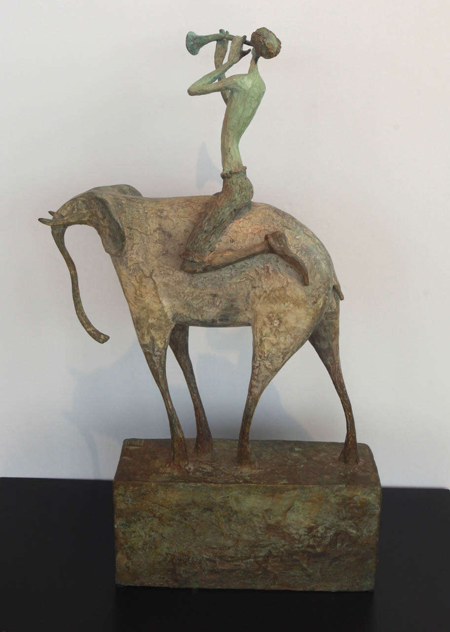 Contemporary bronze sculpture by Elena Boukingolts is #7 of a series of 12.
The bronze elephant contentedly carries his rider who just as contentedly blows his horn.