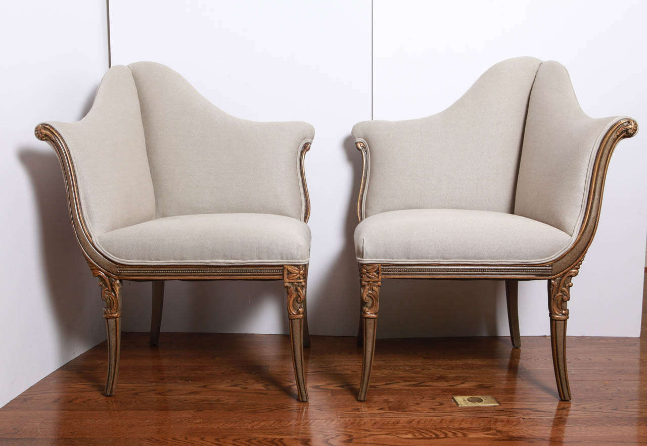 The pair of carved vintage tete a tete chairs are upholstered in a dark linen fabric with double welt. The carvings on the legs and frame are clean and crisp. The tete a tete chairs were first used in France in the late 17th century and were