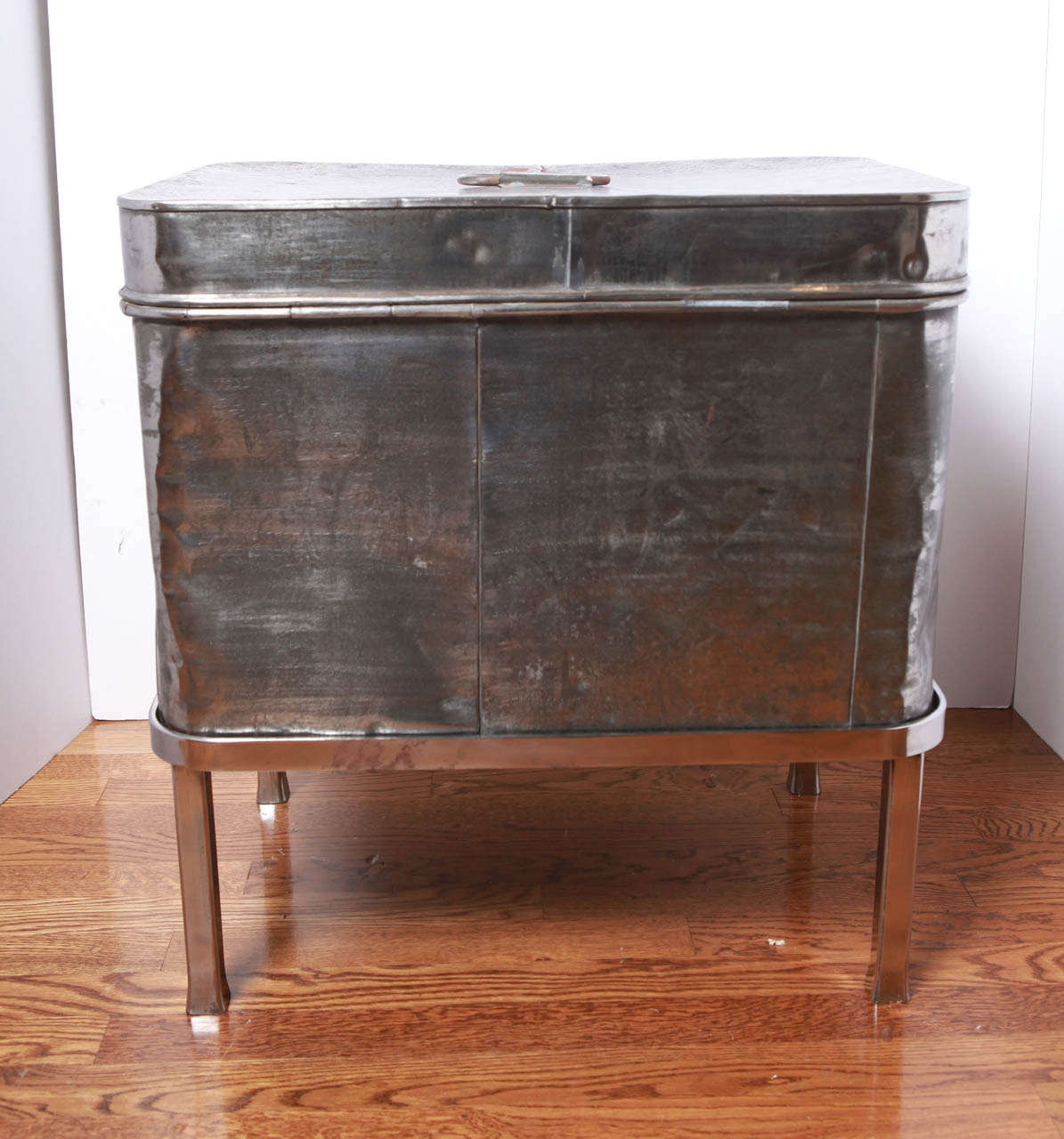 This 19th century steel hat box on metal legged stand could easily hold your 