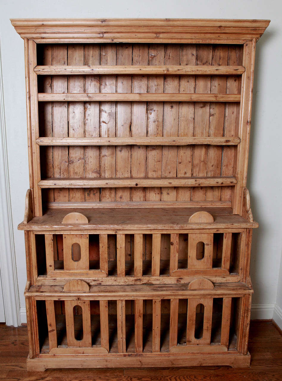 This 18th century Pine Welsh Cupboard with sliding railed bottom compartments, often referred to as 