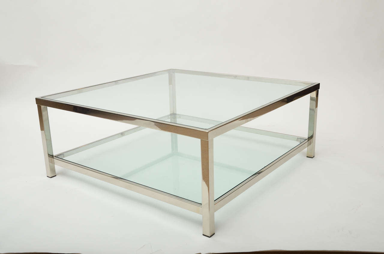 A chrome and glass square coffee table.
