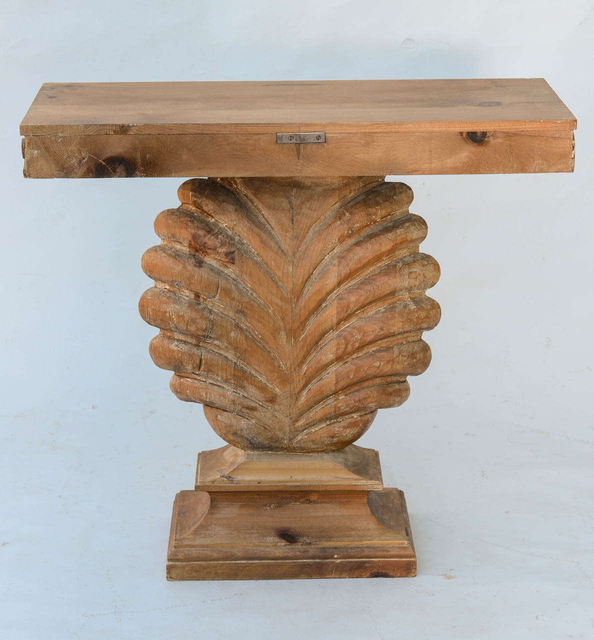 Shell-carved console, of pine, having a rectangular top with evolute scroll apron, raised on concave plinth. Edward Wormley for Dunbar.