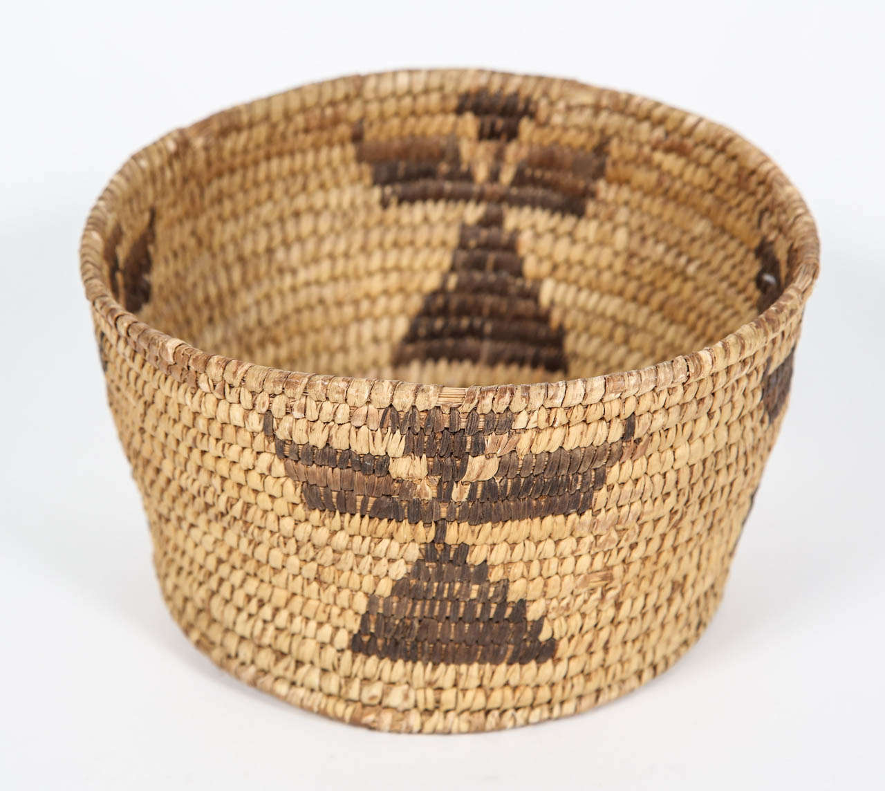 Small vintage woven basket with tribal pattern made by the Papago. 

The Papago, now known as the Tohono O'odham, are a Native American group who primarily resided in the Sonoran Desert of southeastern Arizona and northwestern Mexico. Today there