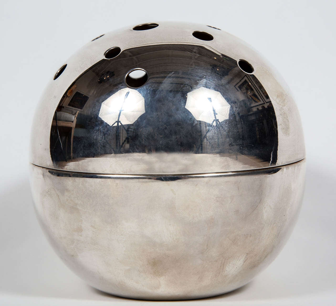 Spherical sterling silver bud vase by Christofle of Paris. Vase comes apart for easy care. Makers mark stamped on bottom. 

Christofle is a manufacturer of fine silver flatware and home accessories based in France. It was founded in 1830 by