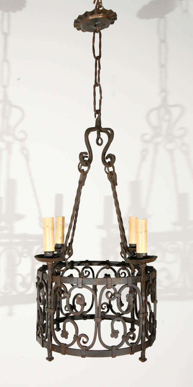 French iron chandelier; newly wired; four candelabra sockets will each take a 65-watt bulb.