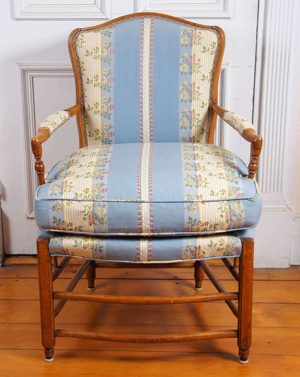 French provincial beechwood fauteuil with padded ladder back and arms.
Loose cushion. Lovely striped moire damask with flowers. In blues and
cream. Trimmed in gimp on back and arms.