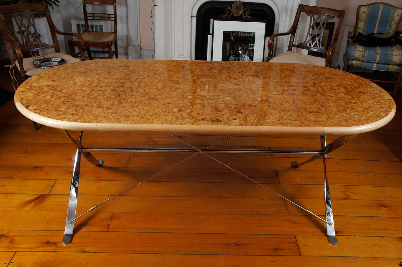 Handsome oval maple burl dining room table supported by  polished steel base. Newly polished and in tip-top condition.  Seats 6-8.