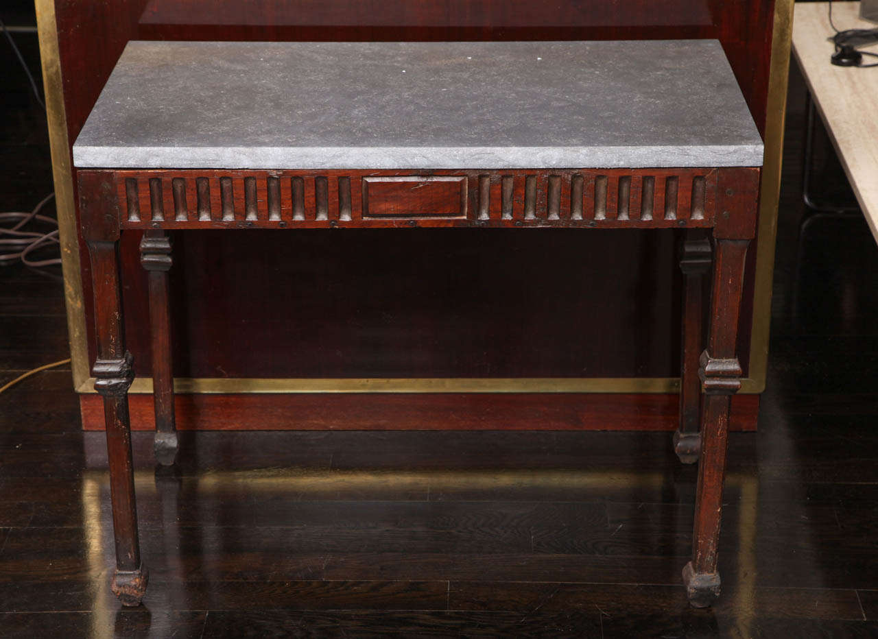 19th C. Italian Walnut occasional table with fluted apron, carved square leg accents and feet. The top is honed Petite Granite.