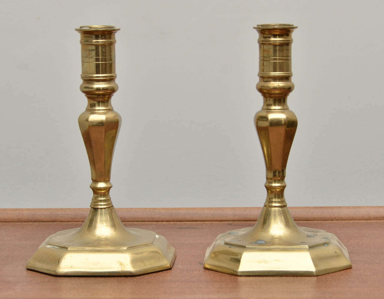 Pair of early 20th Century Brass Candlesticks - one has some spots of patina on it.