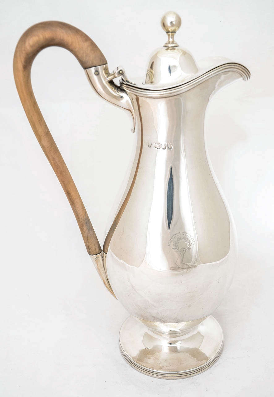 This beautiful and elegant English silver jug was made by the eminent London silver firm of Charles Stuart Harris in 1890. The style is neoclassical and the height to the top of the wood handle is 29cms.