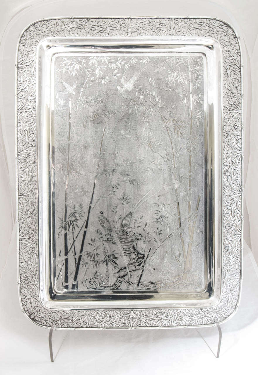 A magnificent Chinese Export Silver Tray made by Wang Hing circa 1880. The tray is finely engraved all over with birds and bamboo; and the same decoration is used for the intricately pierced border. 
The tray weighs 2270gms and measures 56.5cms x
