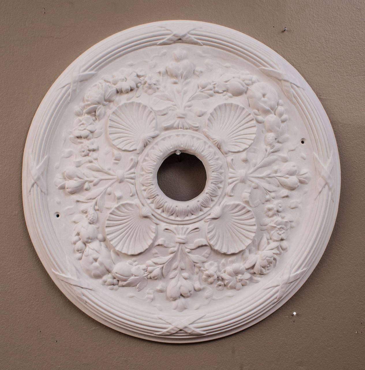 We offer a variety of plaster ceiling medallions that are hand-cast by our own craftsman from molds made from period medallions in period rooms. This collection of four is illustrated as a wall decoration, and the price is for all four. Diameters,