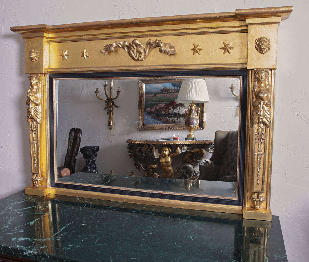 Early 19th c Regency period overmantle mirror. Hand carved Egyptian caryatids . Lion heads and star detailing