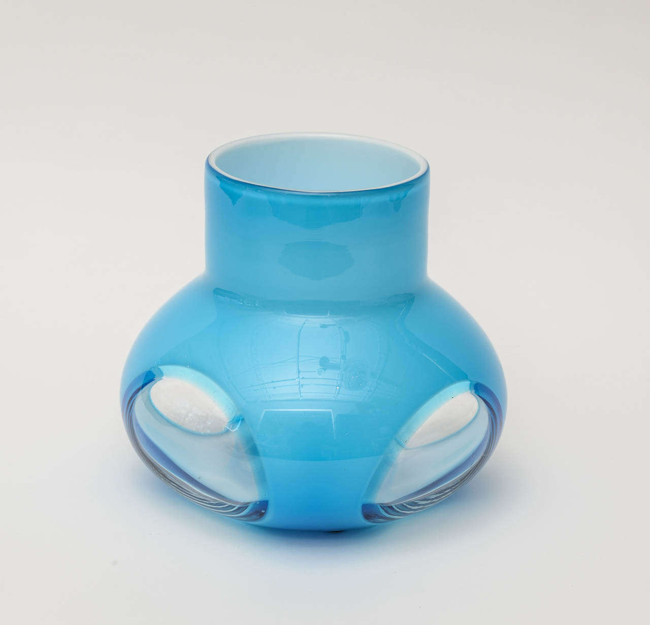 White cased inside meets luscious turquoise and a mix of robin's egg blue glass vase with large frames of oval shapes seen to the inside.
The opening of the hole for flowers is 4