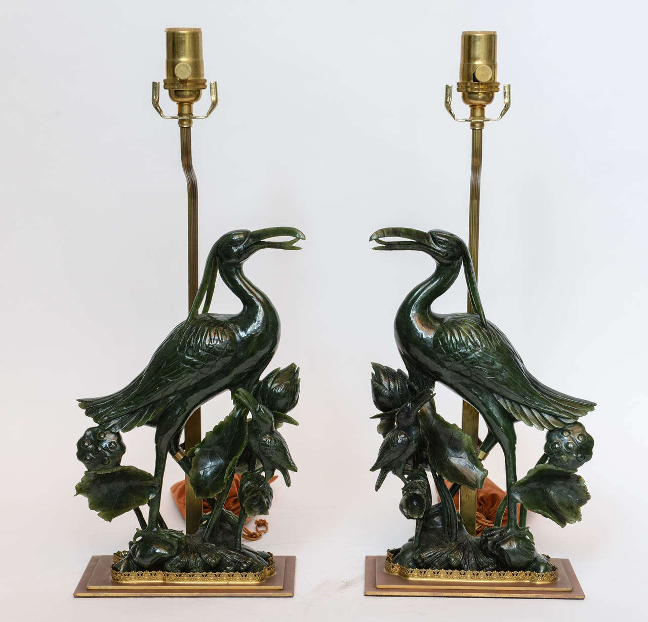 A pair of fine jasper jade Chinese hand-carved cranes with water lilies and chicks.
