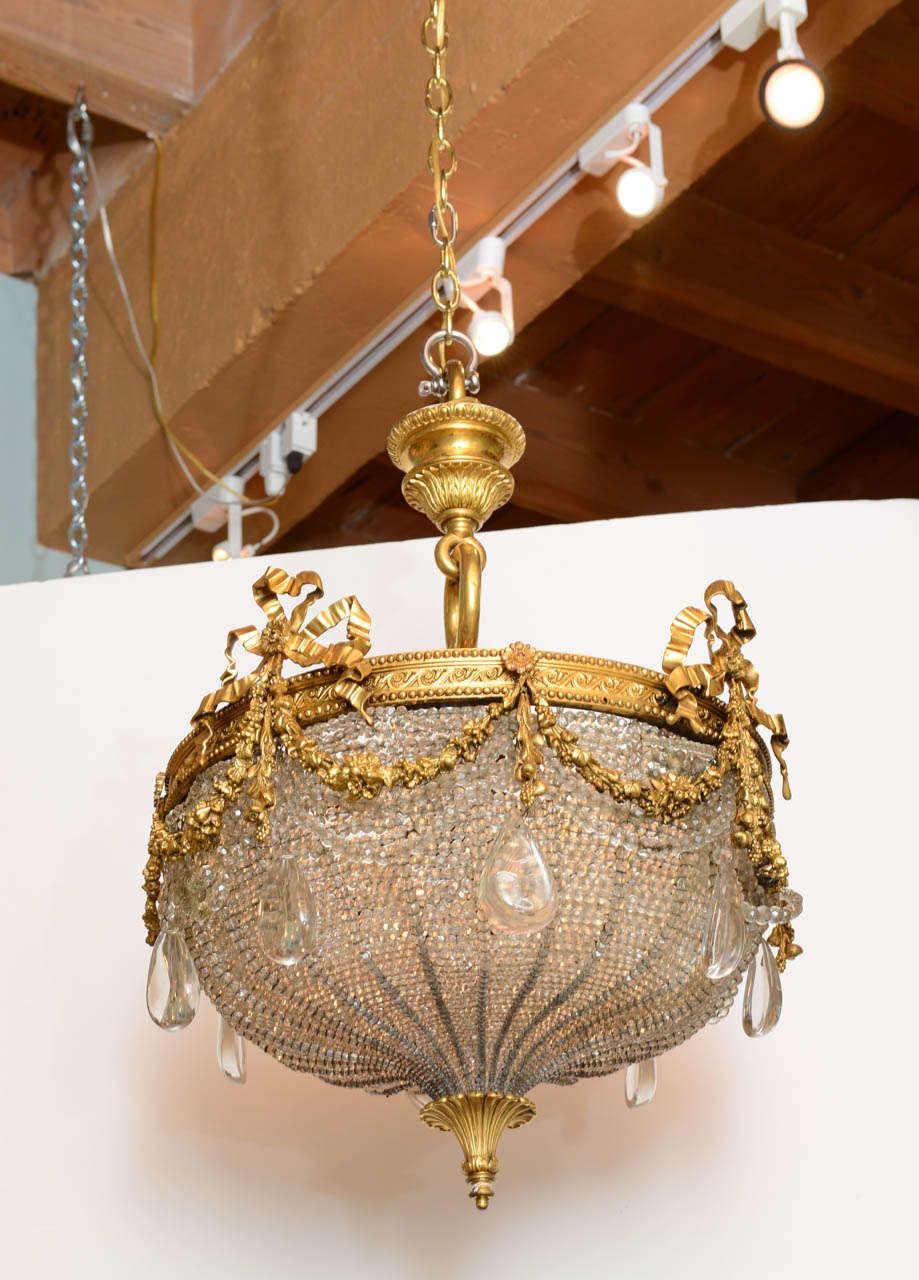 A gilt bronze ribboned and wreath beaded chandelier by E. F. Caldwell
Circa 1900