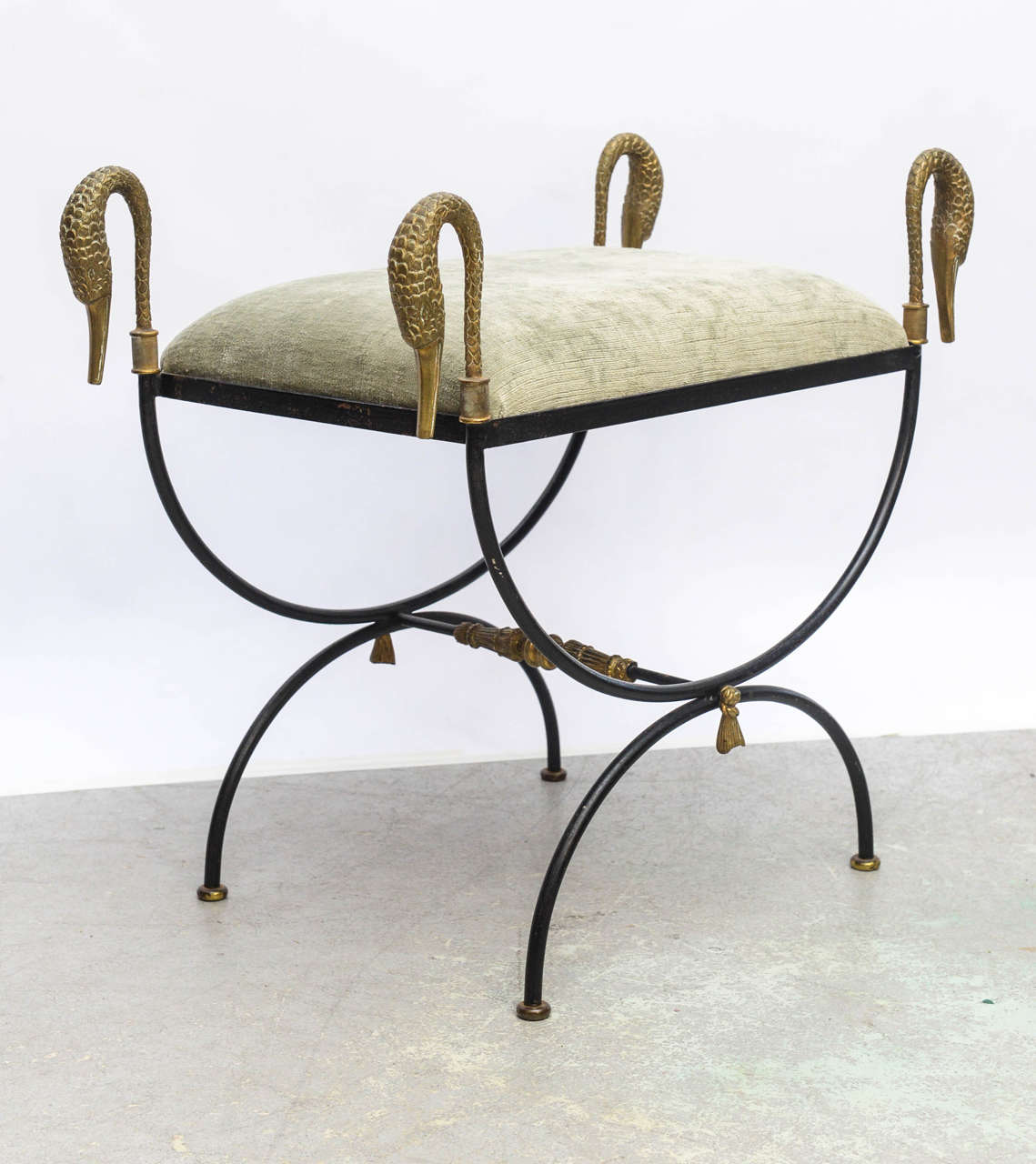Elegant pair of iron benches with chased bronze swan heads. Reupholstered in sage green silk velvet.