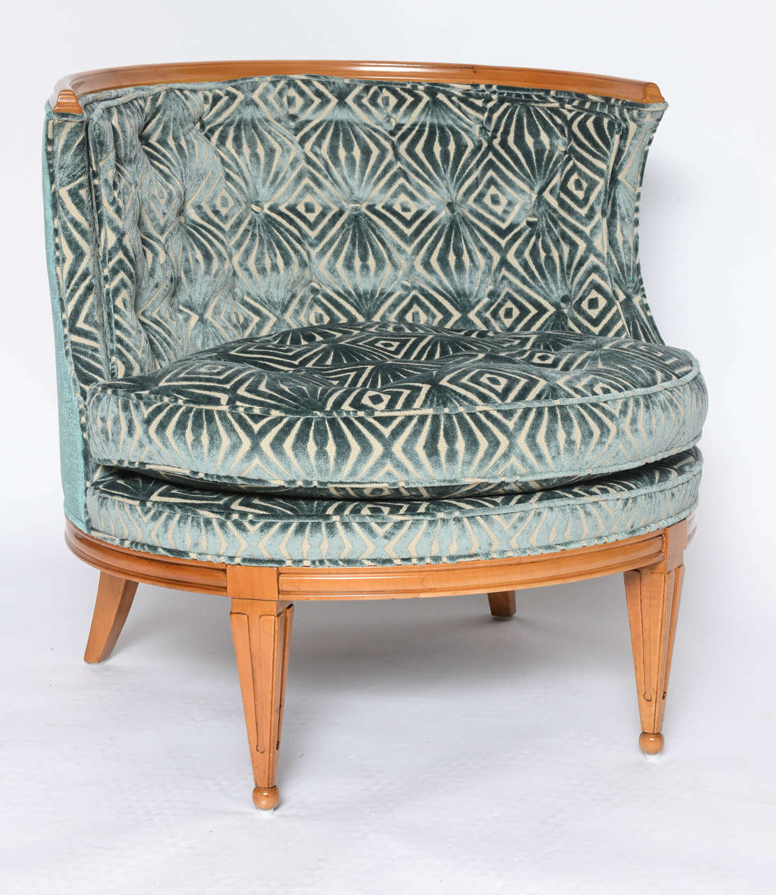 Such a luxurious single slipper chair in rich velvet. Curved back and wood base.
