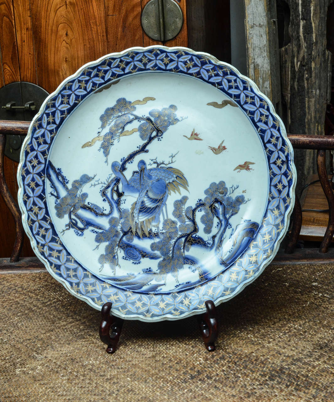 Mid-19th century Japanese porcelain blue and white imari charger with gold leaf overlay.