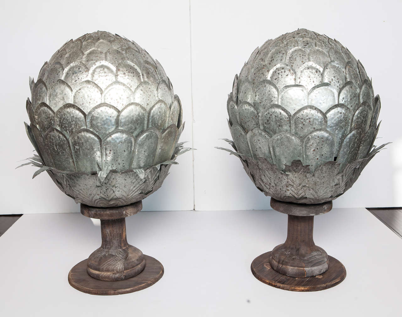 Galvanized metal and wood artichokes on wood base. Each artichoke consists of two separate pieces.