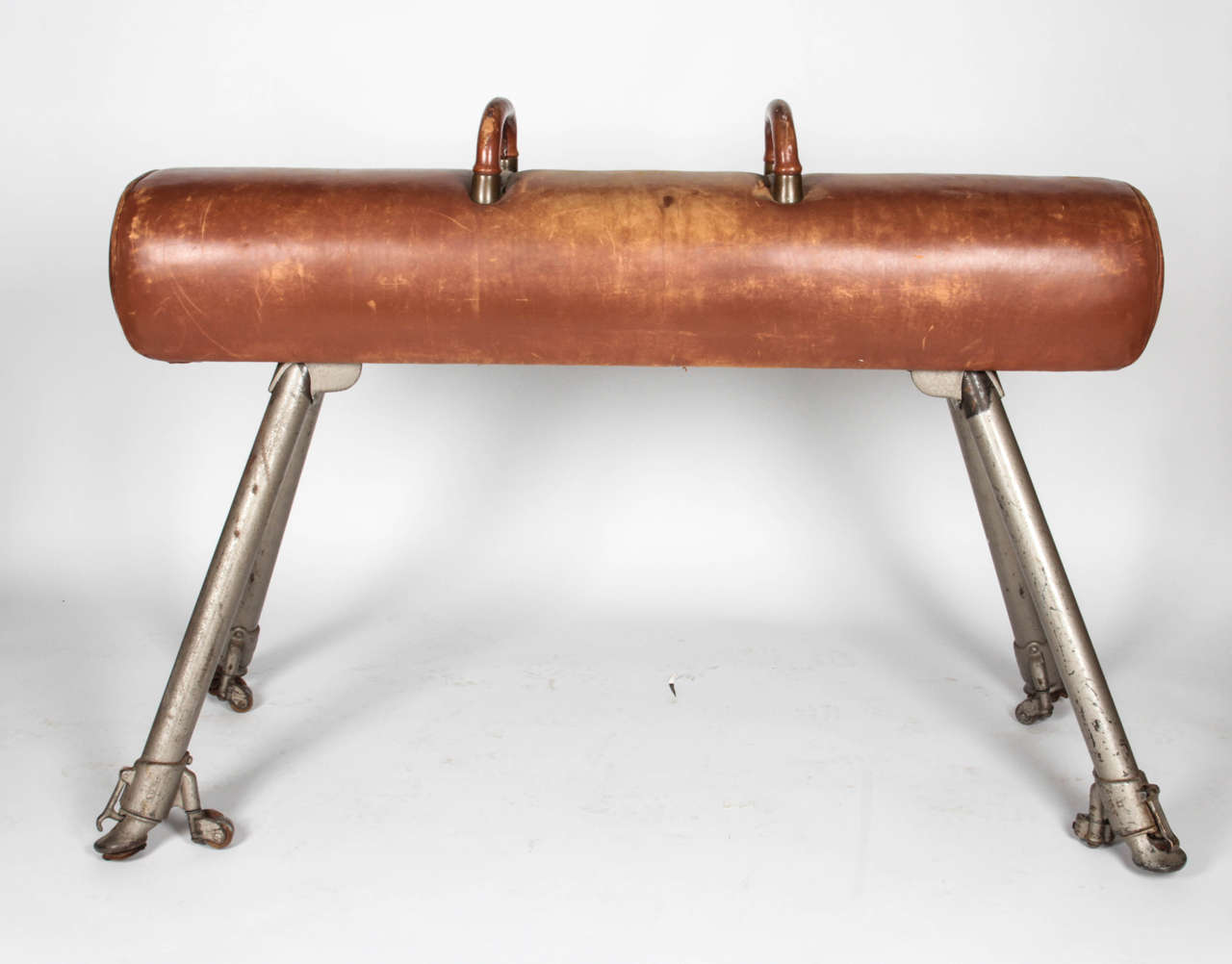 Vintage gym pommel horse with a worn leather surface and handles. 

*Not available for sale or to ship in the state of California.